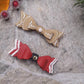 Video close up of Christmas Bow Barrettes on a  stone background surrounded by foliage