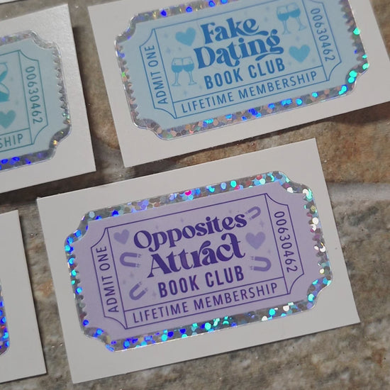 video of Book Trope Stickers on a stone background surrounded by foliage. 