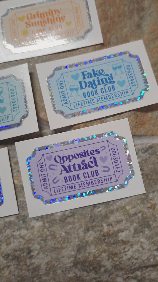 video of Book Trope Stickers on a stone background surrounded by foliage. 