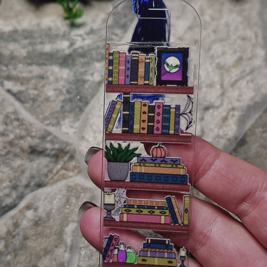 video of spooky bookshelf bookmark on a stone background