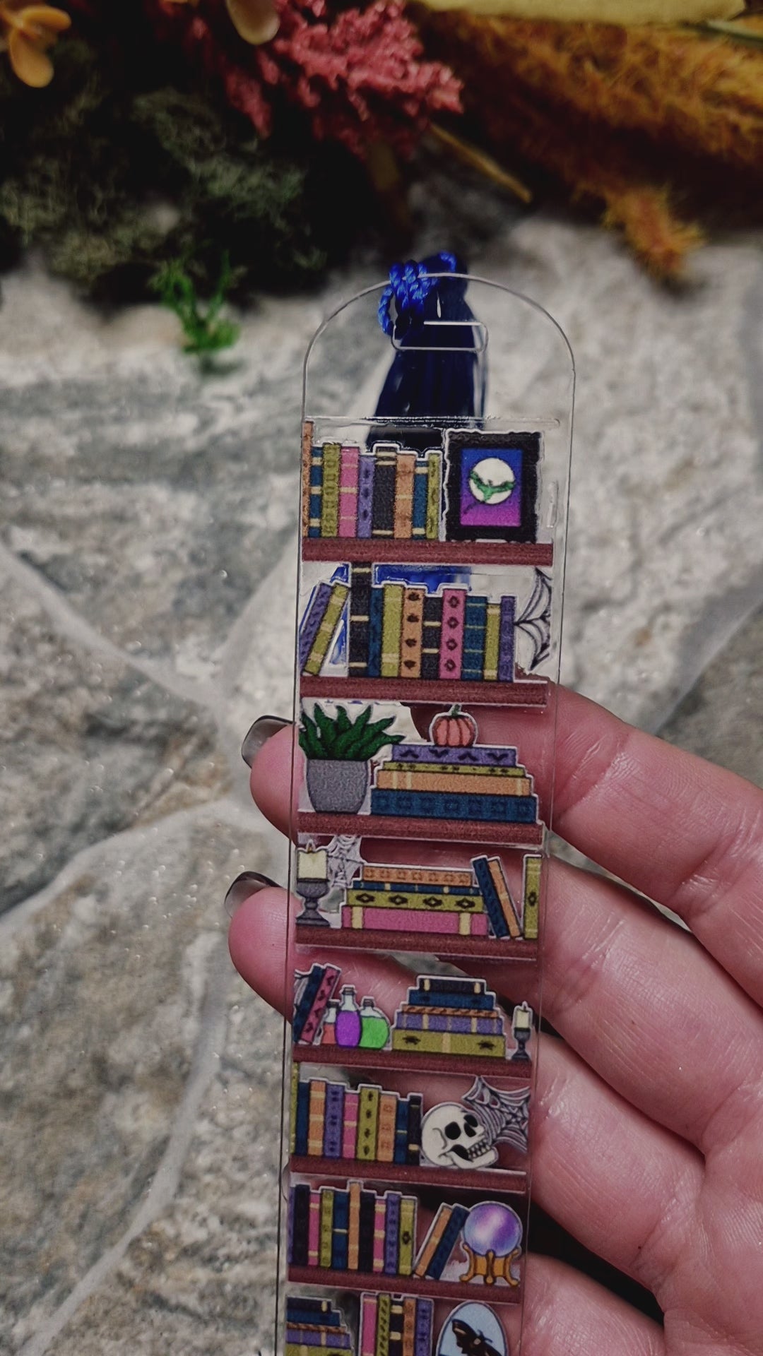video of spooky bookshelf bookmark on a stone background