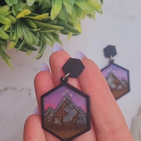 video Close up of night court earring on a marble background surrounded by foliage