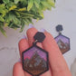 video Close up of night court earring on a marble background surrounded by foliage