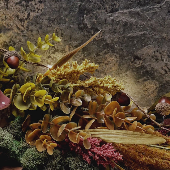 video of Enchanted rose suncatcher on a stone background surrounded by foliage 

