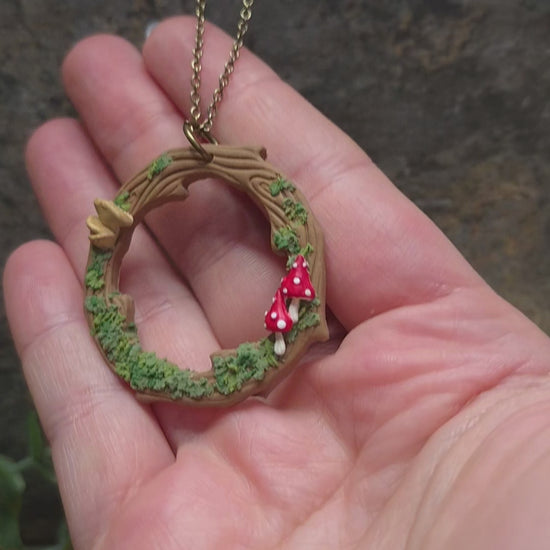 video of Mushroom Wreath Necklace on a stone background surrounded by foliage
