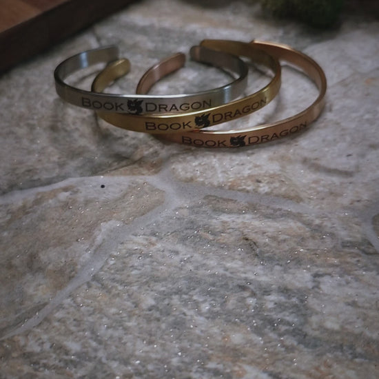 video of Book Dragon bracelets on a stone background. 