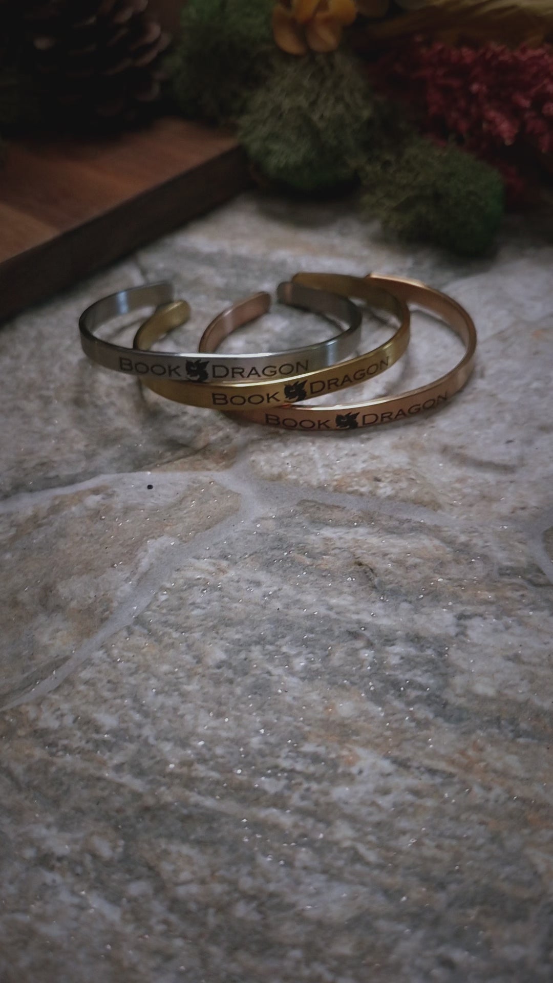 video of Book Dragon bracelets on a stone background. 