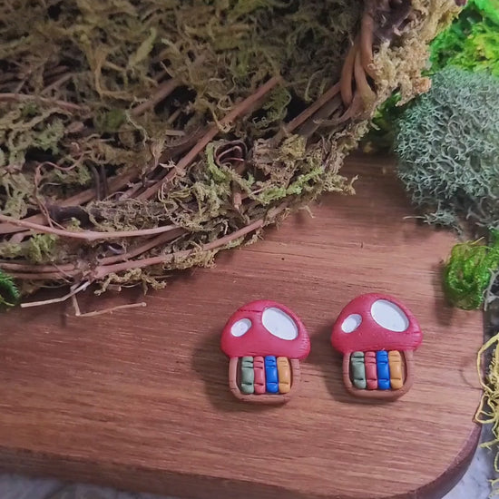 video close up of toadstool studs on wood and stone background surrounded by moss. 