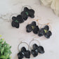 3 pairs of earrings on a white background. Earrings are made of polymer clay. 