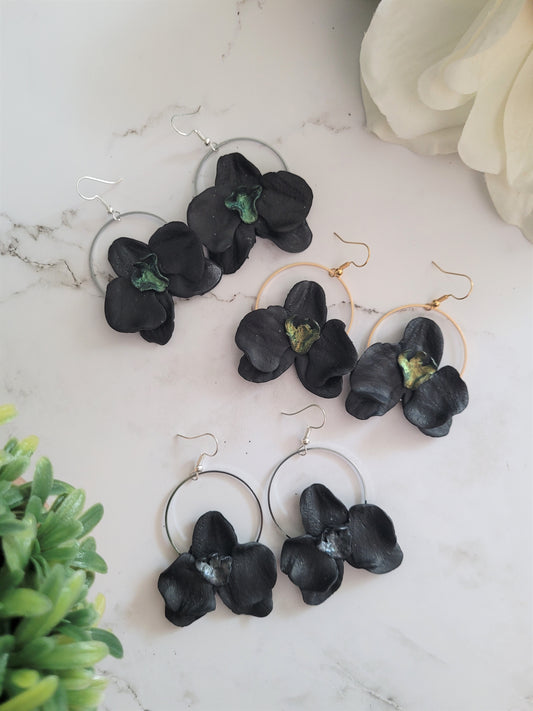 3 pairs of earrings on a white background. Earrings are made of polymer clay. 
