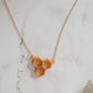 Closeup of honeycomb shaped resin necklace on a white background.