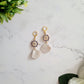 Earrings with gold helm charm and polymer clay sea shell