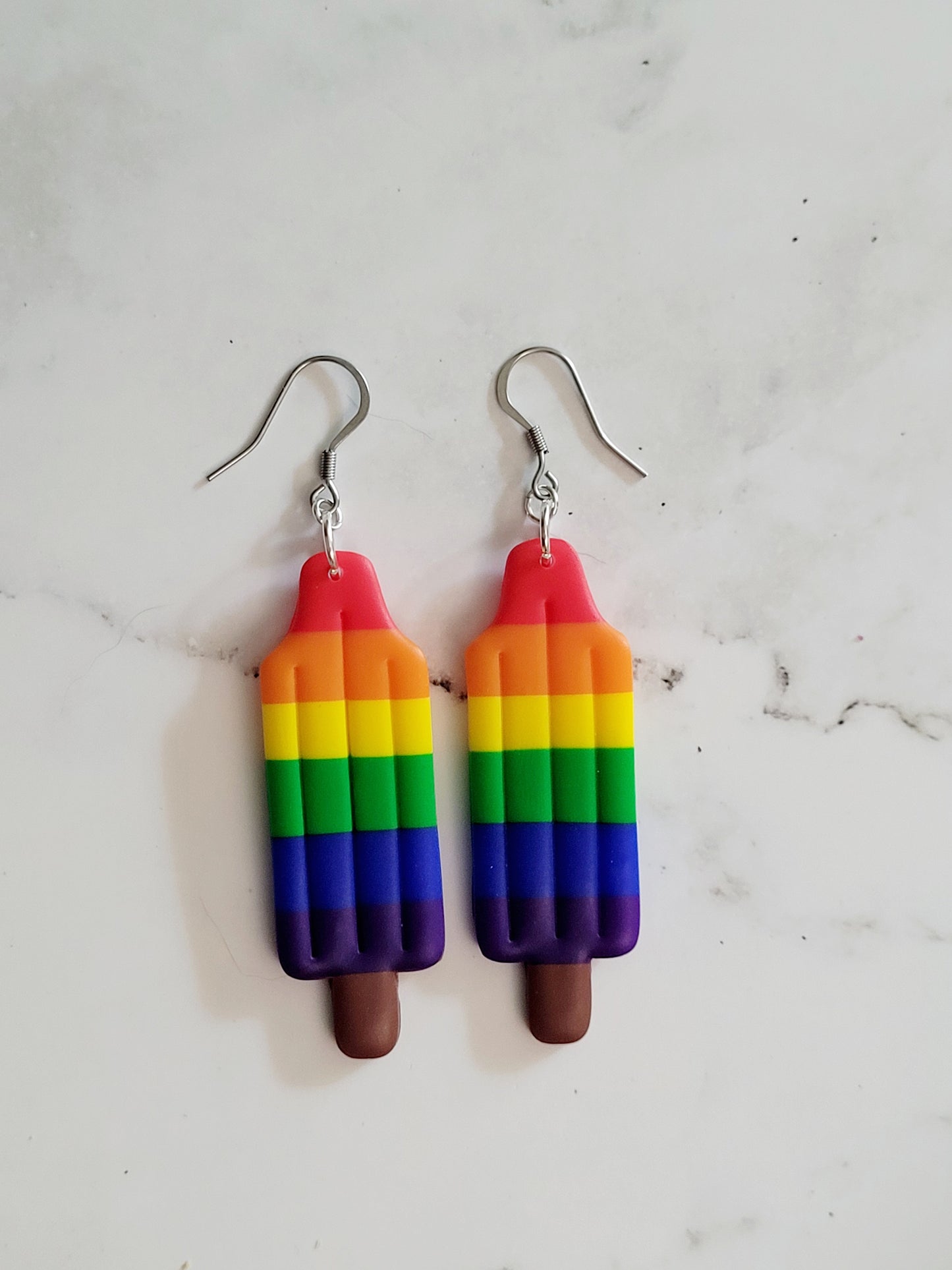 Closeup of the Rainbow Pride Flag Bomb Pop Earrings