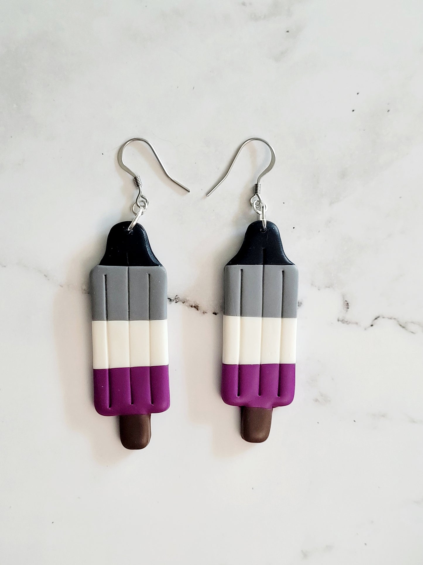 Closeup of the Asexual Pride Flag Bomb Pop Earrings