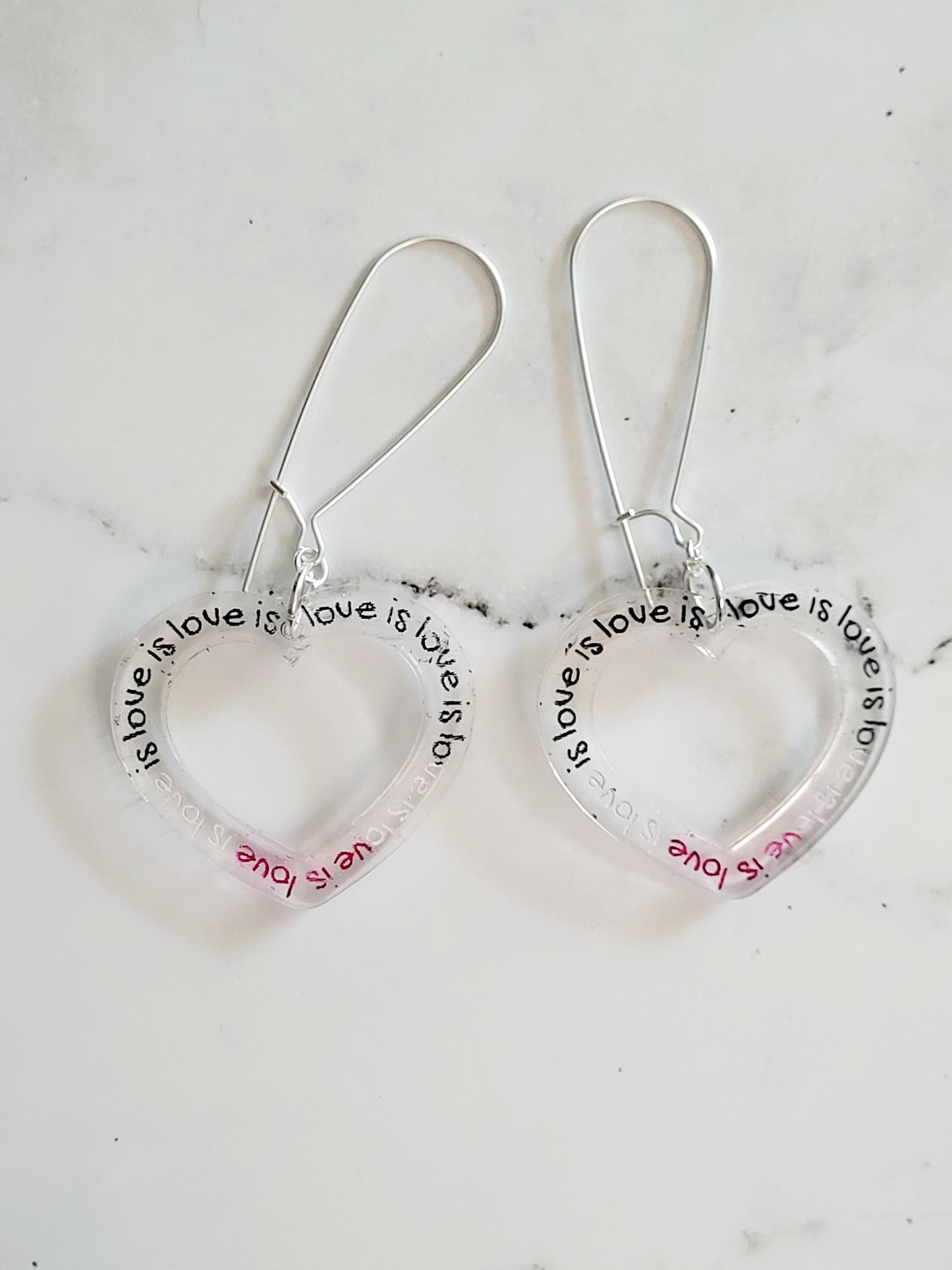 Closeup of the Asexual Love Is Love Earrings