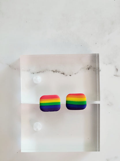 closeup of Rainbow stripe clay in shape of pride flag stud. 