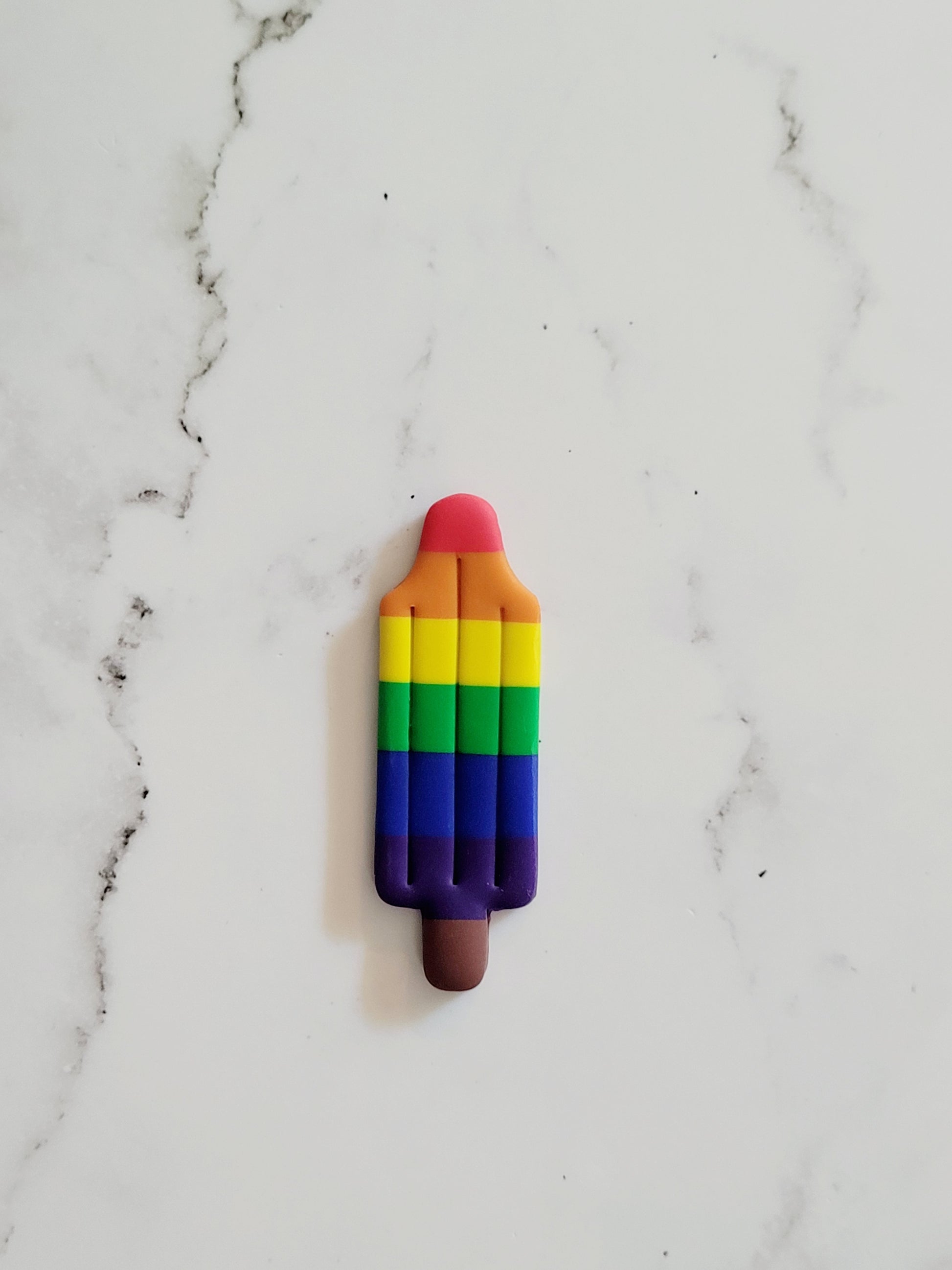 Closeup of the Rainbow Pride Flag Bomb Pop Pin