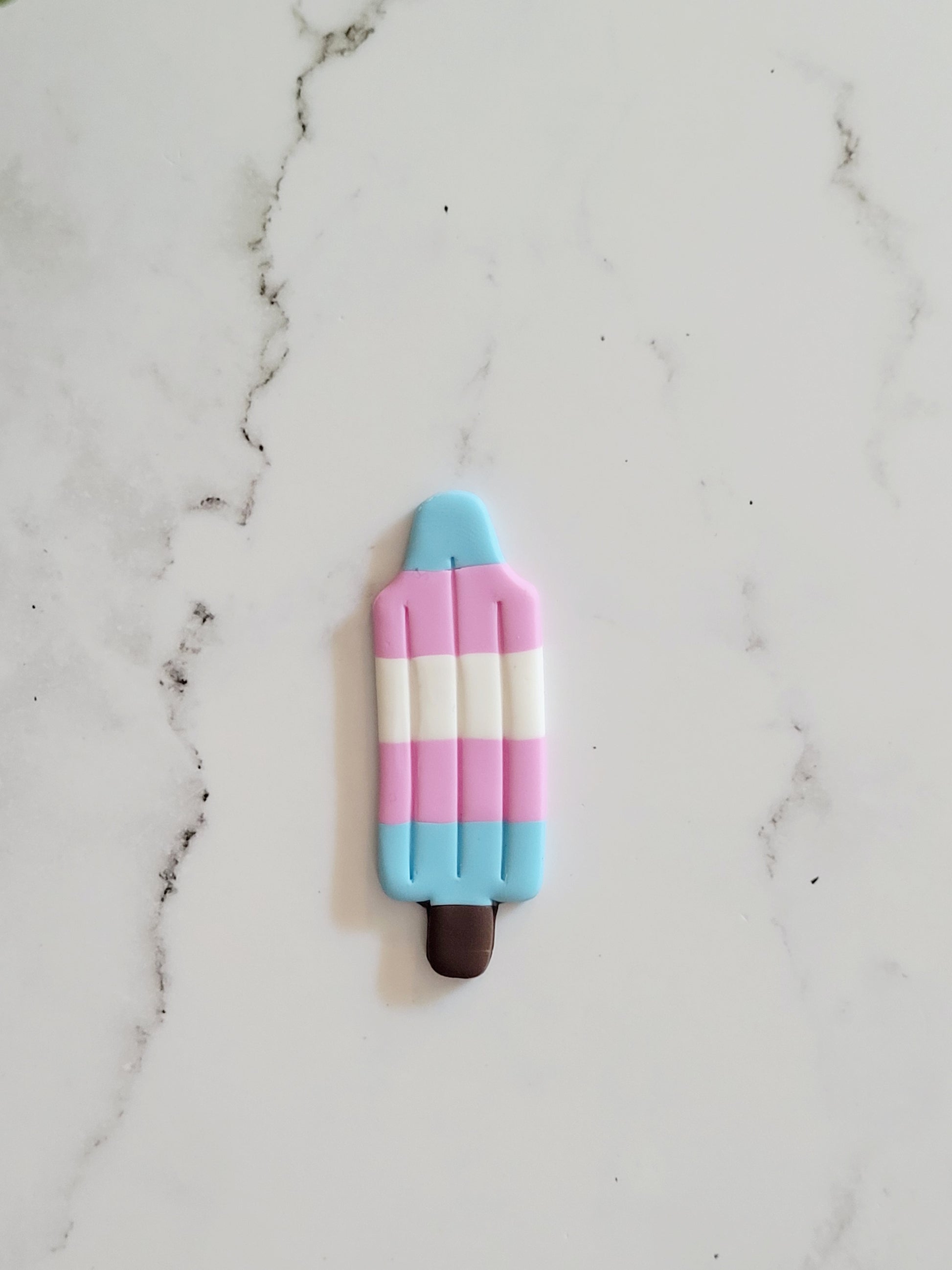 Closeup of the Trans Pride Flag Bomb Pop Pin