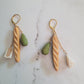 close up of 3d Baguette, wedge of cheese, and pear earrings.