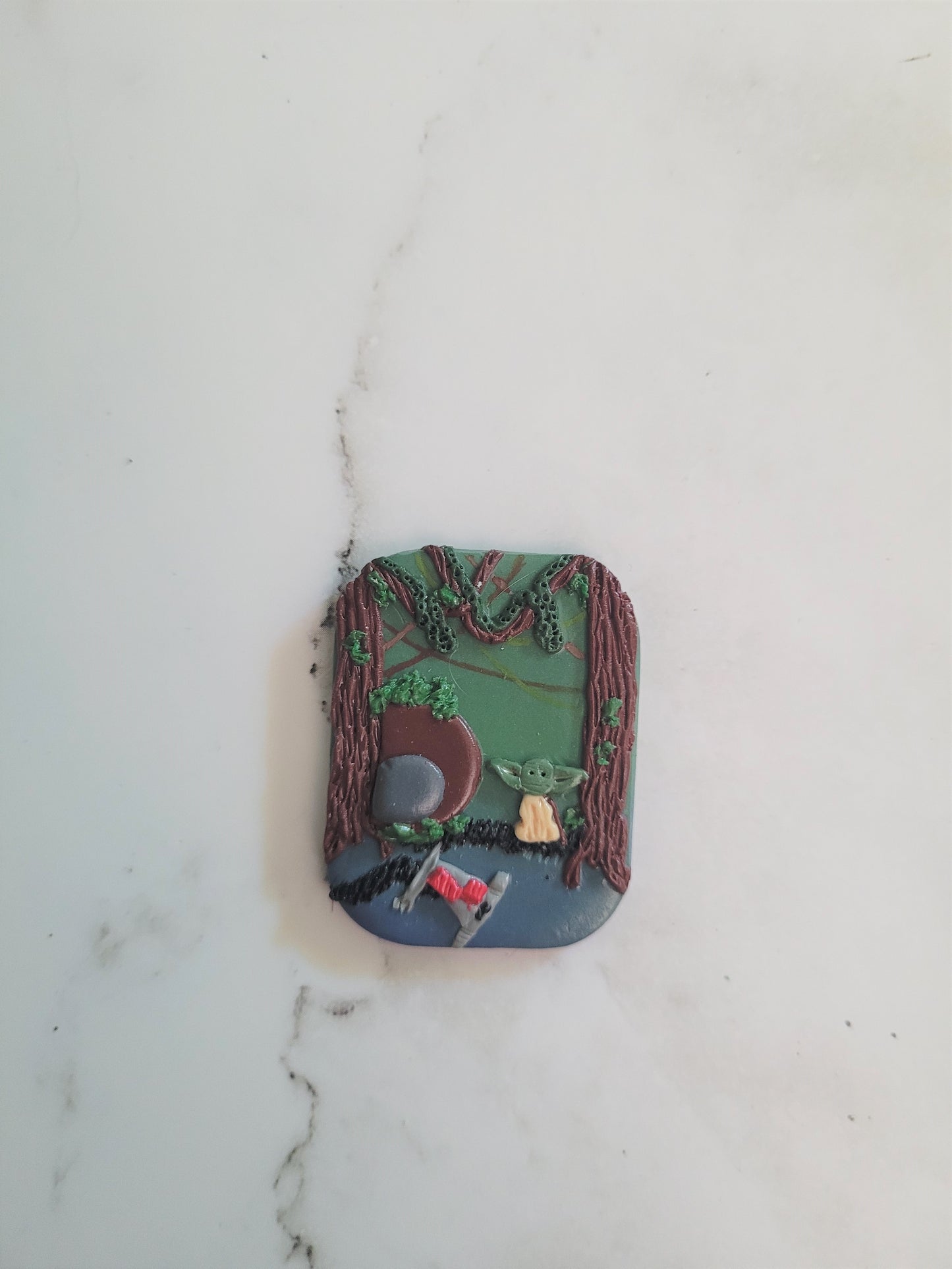 Close up of rectangle Brooch with a swamp landscape
