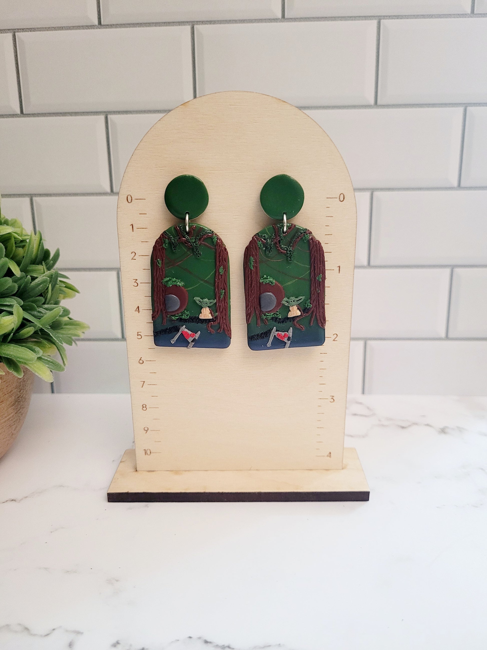 Arch earrings with a swamp landscape on a ruler