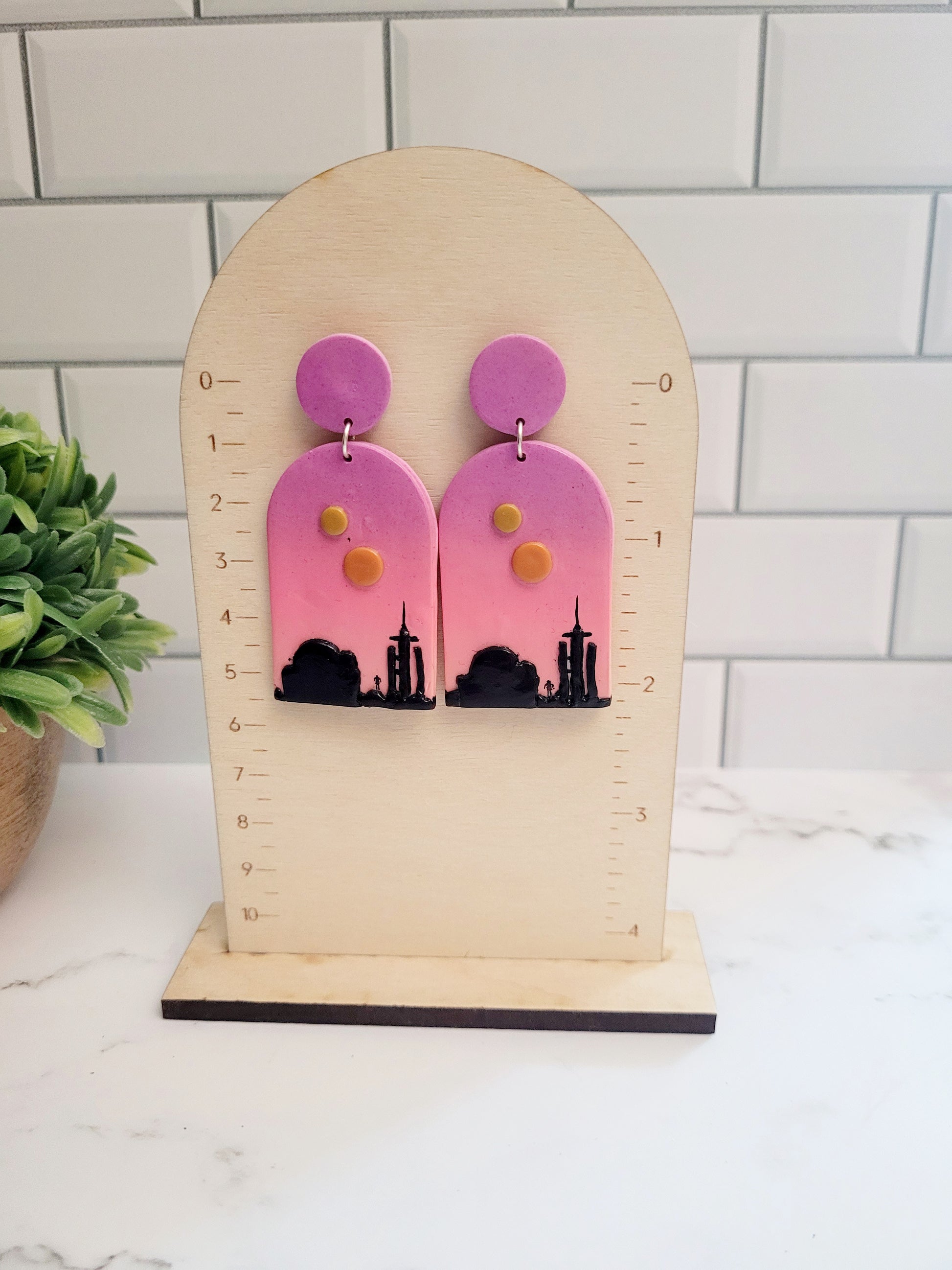 Arch earrings with a sunset landscape on a ruler