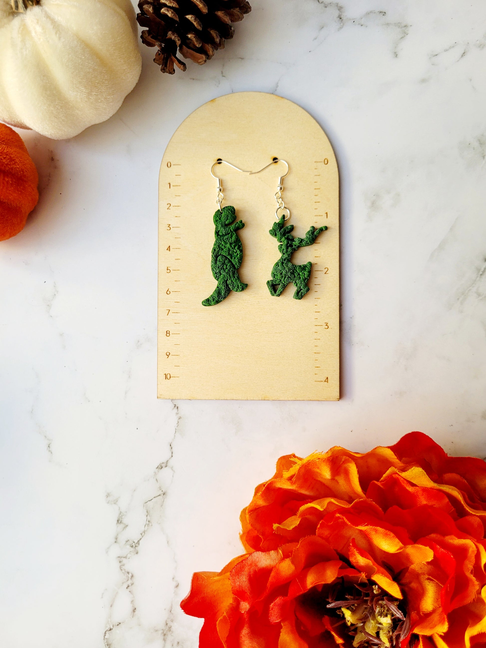 Edward Scissorhands themed topiary earrings on a ruler background.