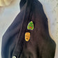 Mummy and Creature of the Black Lagoon monster pins on a black cardigan. 