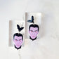 close up of dracula dangle earrings on a white marble background 