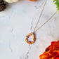 fall harvest themed teardrop necklace on a marble background