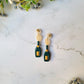 exploding champagne bottle with cork studs on a marble background. 