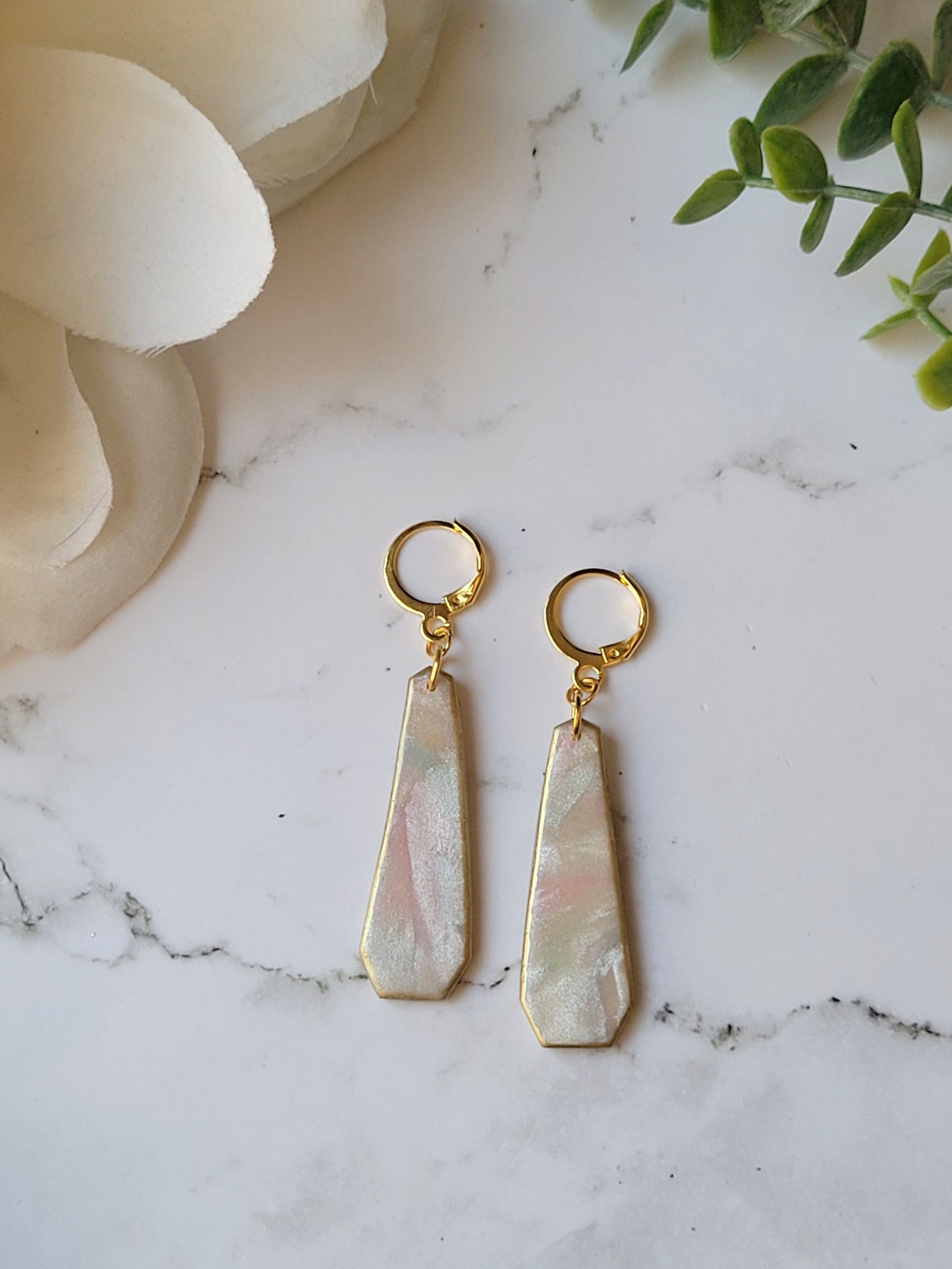 close up of faux mother of pearl clay earrings