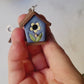 video showing all the sides of the 3d birdhouse earring. 