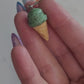 closeup of 3d mint chip ice cream cone earrings. 